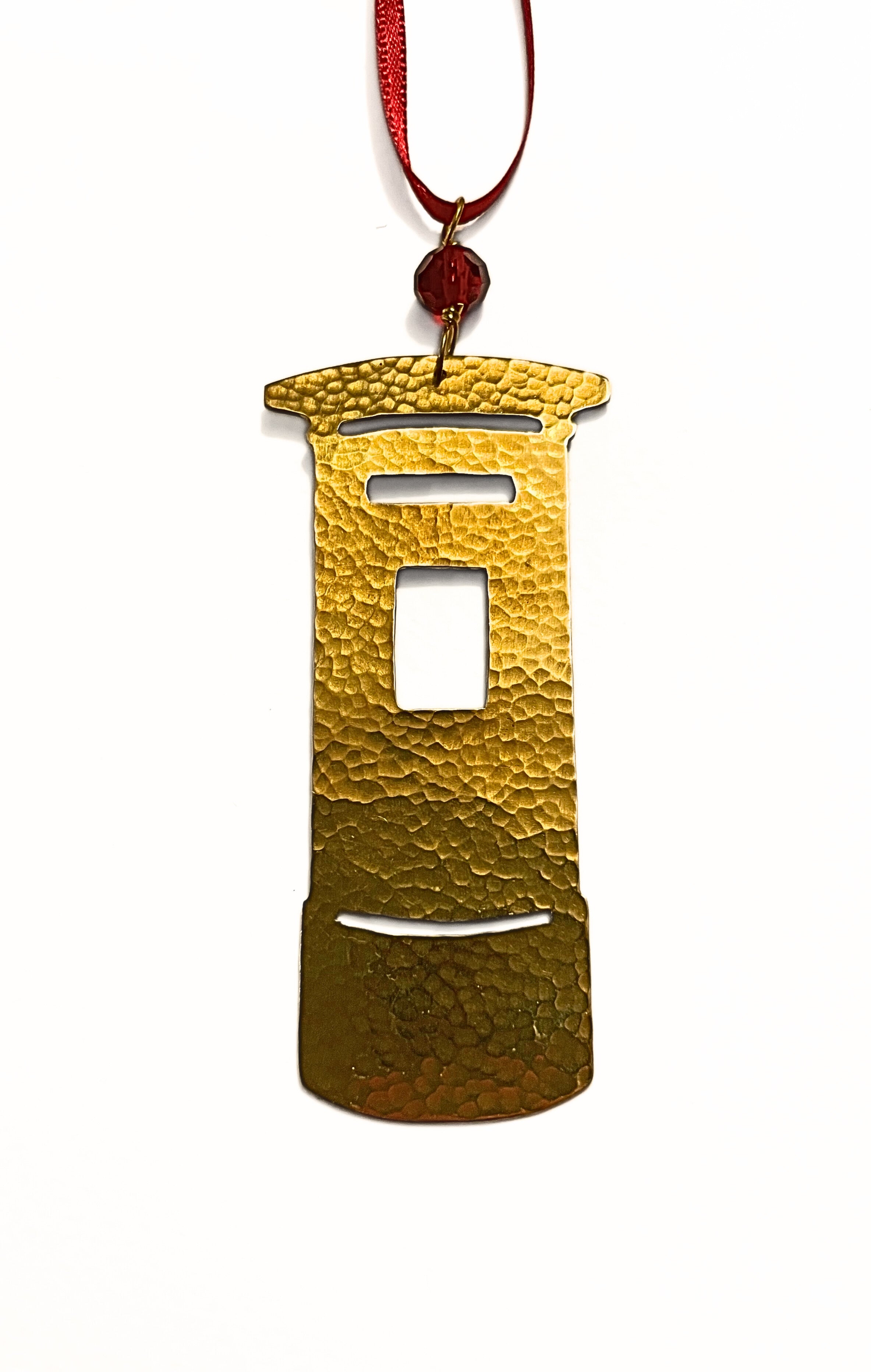 Gold ornament shaped like a traditional Post Box on a white background