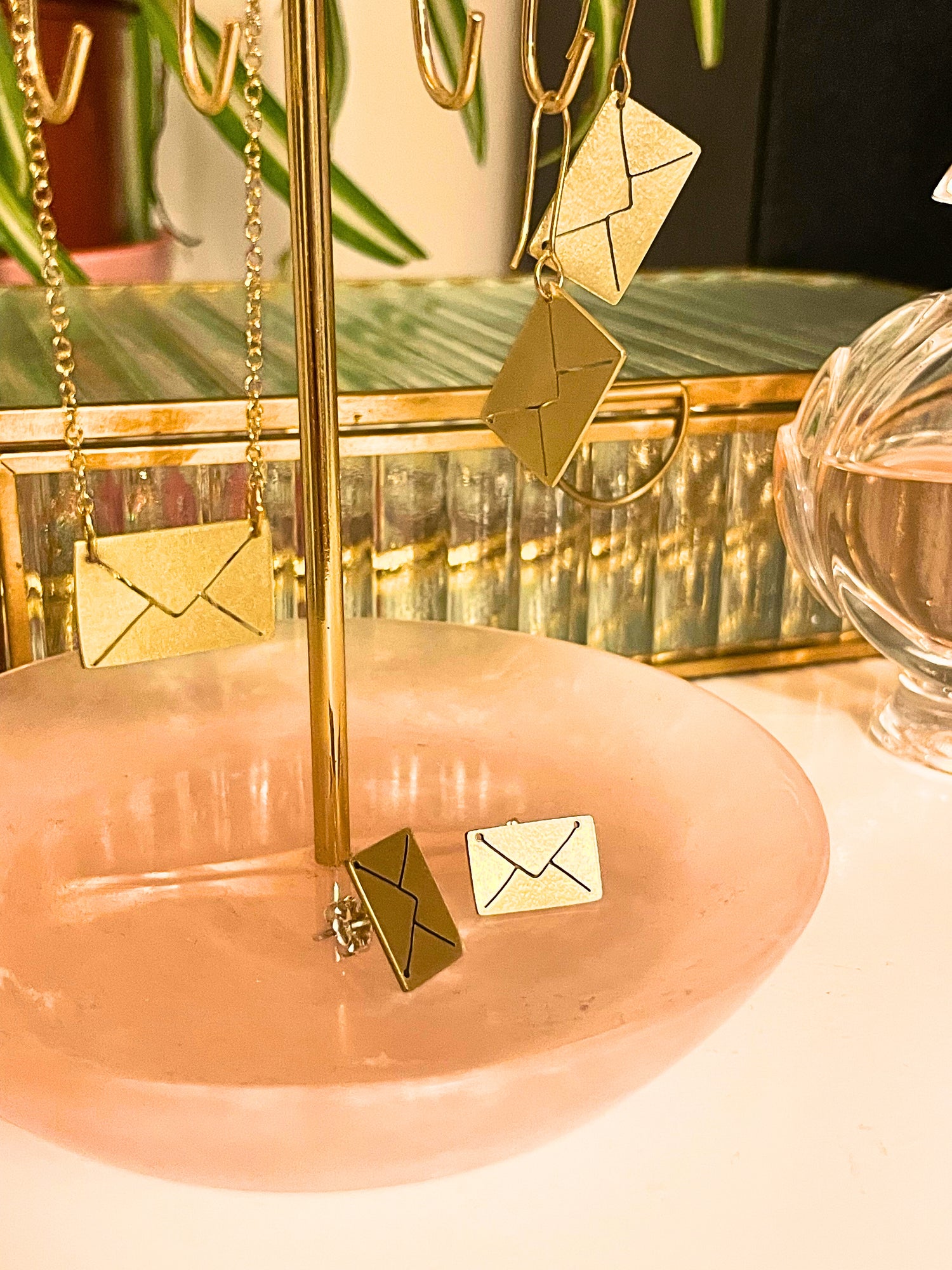 Gold earrings on a stand with a blurred background
