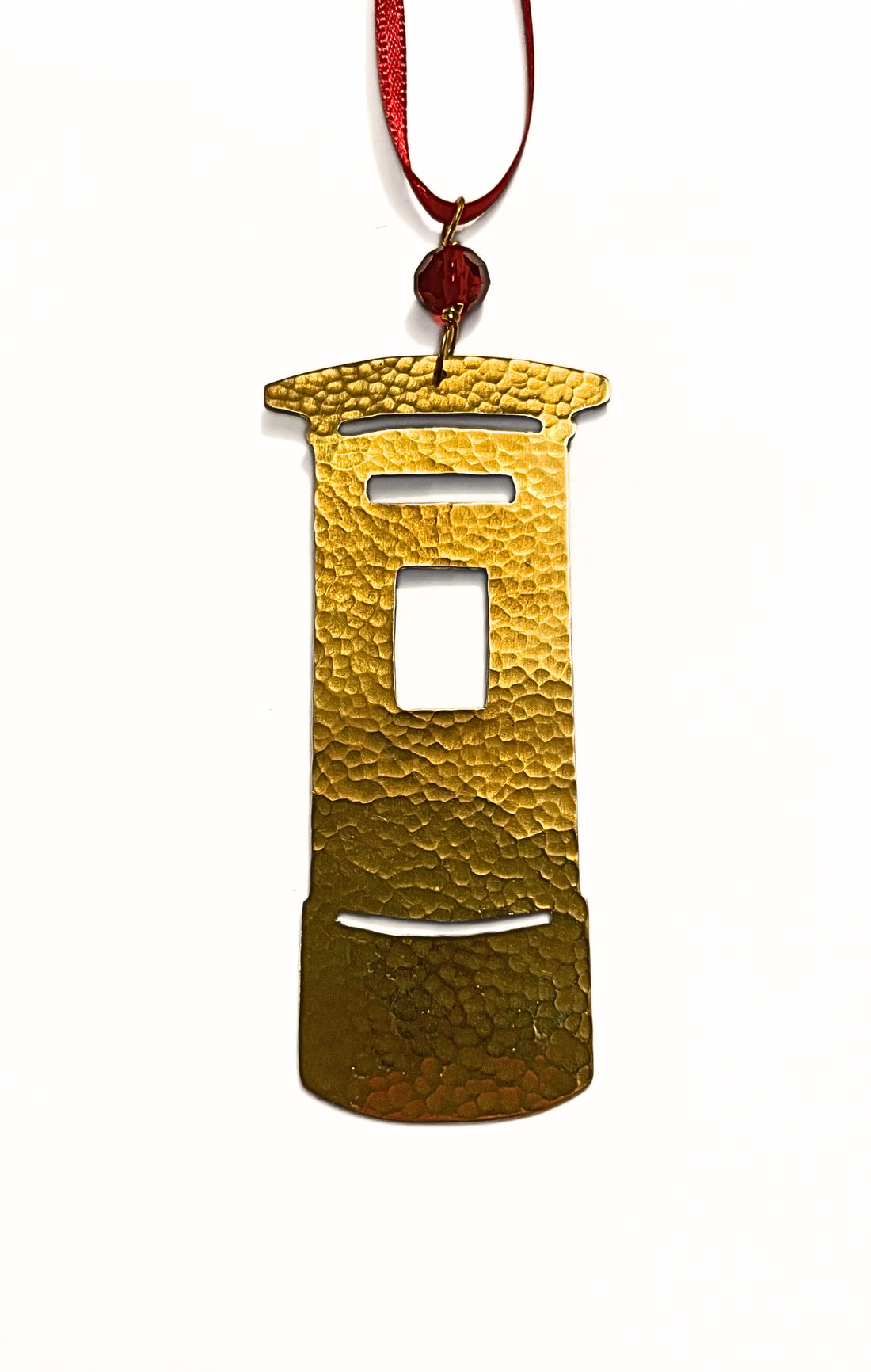 Gold ornament shaped like a traditional Post Box on a white background