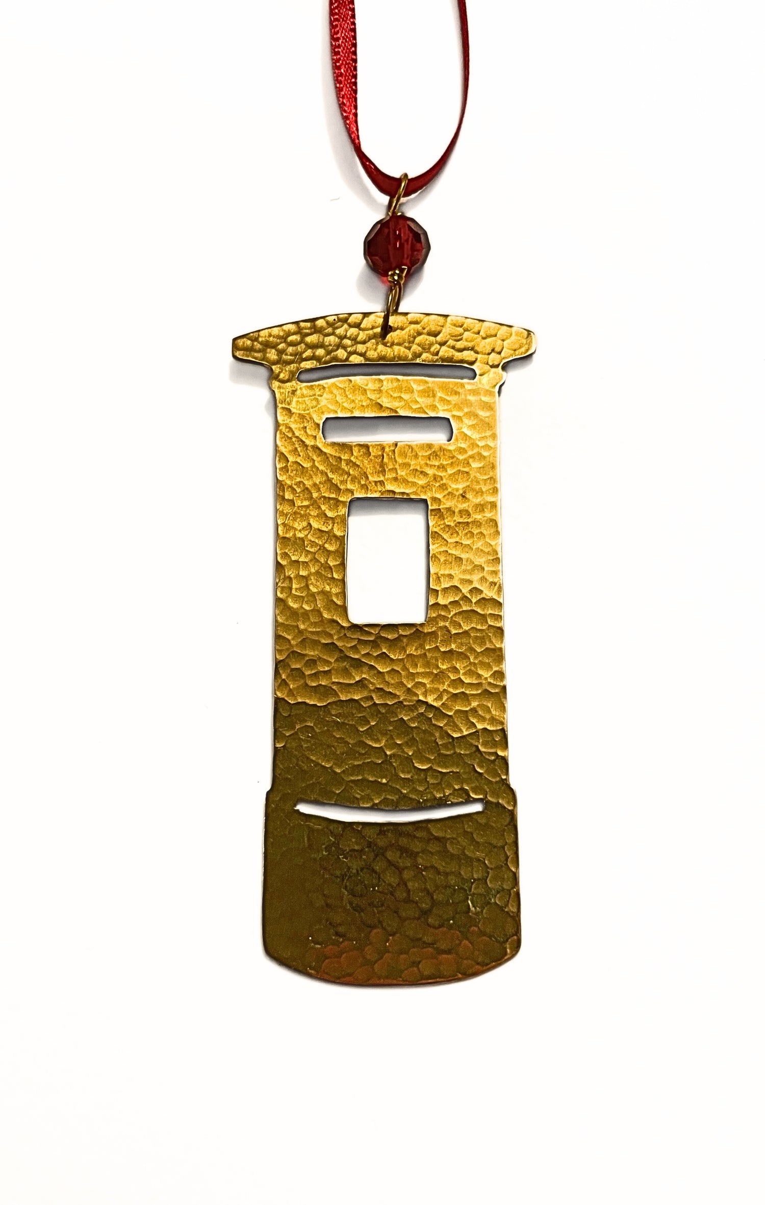 Gold ornament shaped like a traditional Post Box on a white background